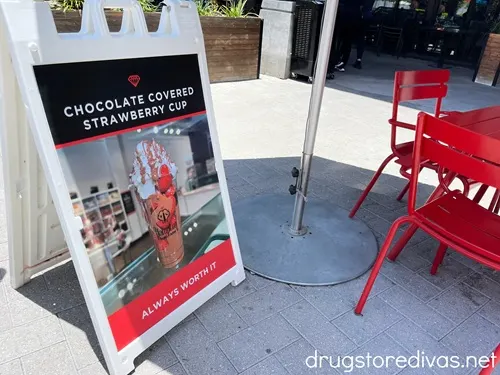A sign advertising a chocolate-covered strawberry cup outside of Hampton Chocolate Factory in Tampa, Florida.