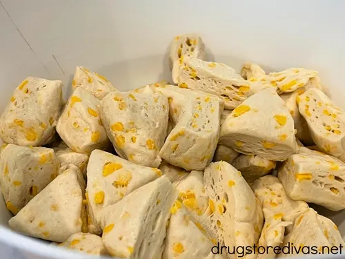 Biscuit dough pieces in a white bowl.