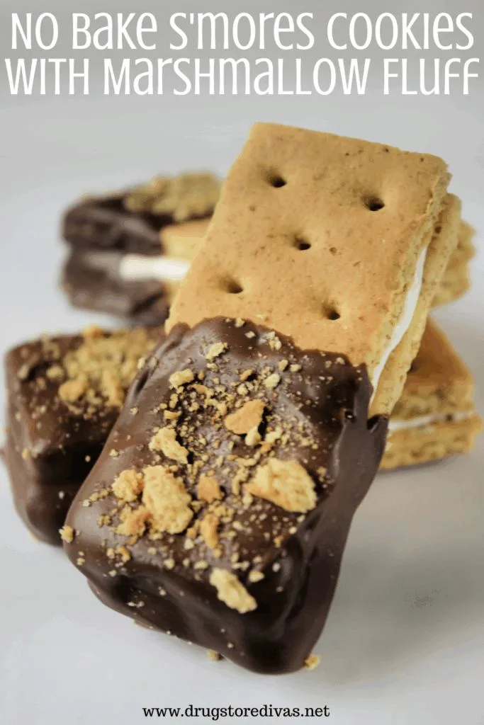 Three graham cracker dipped cookies on a white plate with the words "No Bake S'mores Cookies With Marshmallow Fluff" digitally written on top.