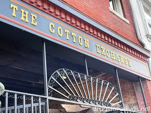 A brick building with a sign on it saying The Cotton Exchange in downtown Wilmington, NC.