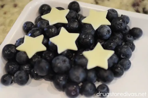 Blueberries with stars on top in the corner of a white tray.