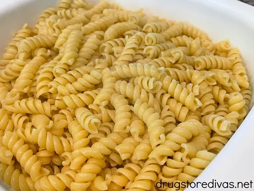 Cooked rotini pasta in a white bowl.