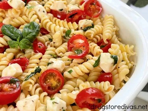 Caprese pasta salad in a white bowl.