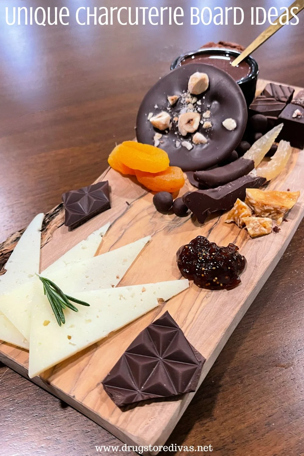 A wooden board with cheese, dried fruit, and chocolate on it with the words 