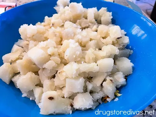 Cooked potatoes in a blue bowl.