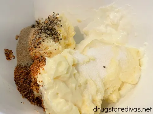 Mayonnaise and seasoning in a white bowl.