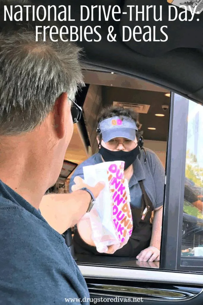 A man in a car being handed a Dunkin' bag through a drive-thru window from a worker in a cap and face mask and the words "National Drive-Thru Day: Freebies & Deals" digitally written on top.