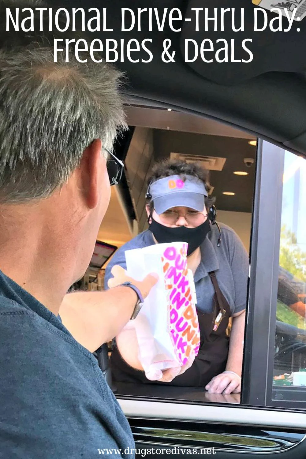 A man in a car being handed a Dunkin' bag through a drive-thru window from a worker in a cap and face mask and the words 