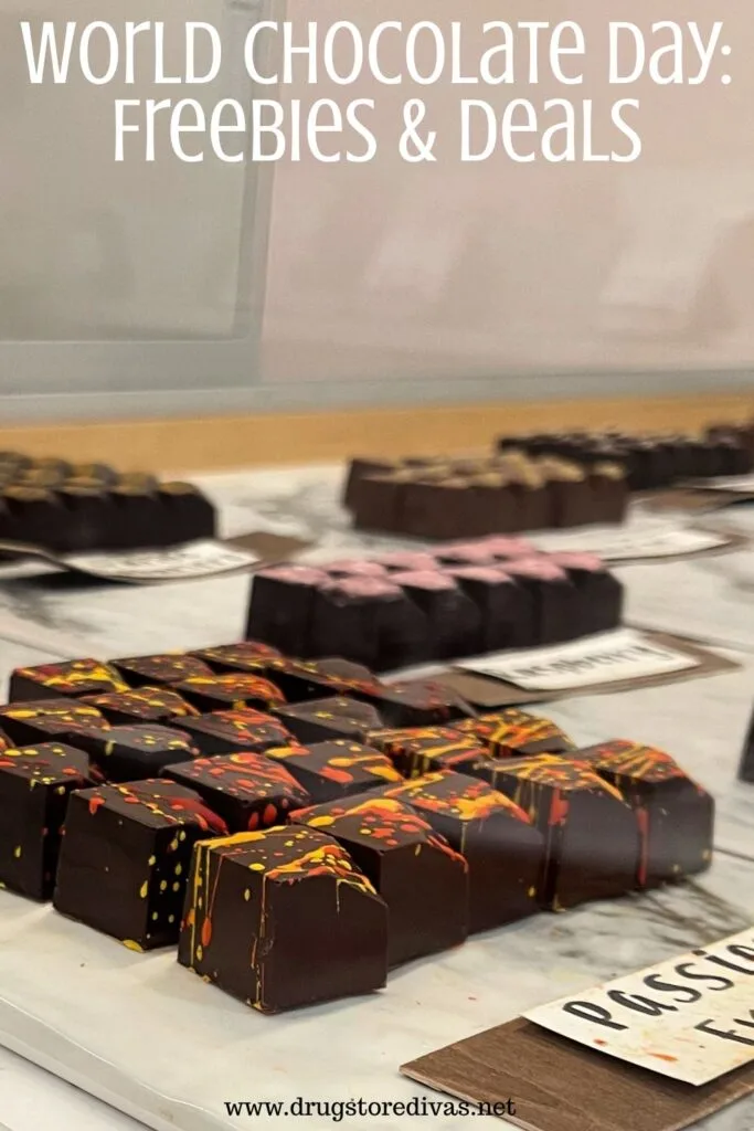 Square chocolate truffles in a display case with the words "World Chocolate Day: Freebies & Deals" digitally written on top.