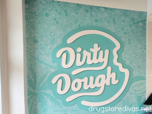 The Dirty Dough logo inside a Dirty Dough cookie shop.