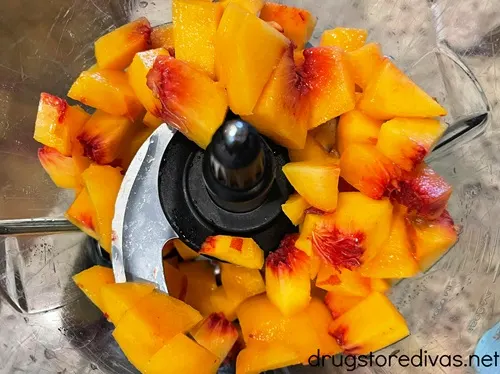 Diced peaches in a food processor bowl.