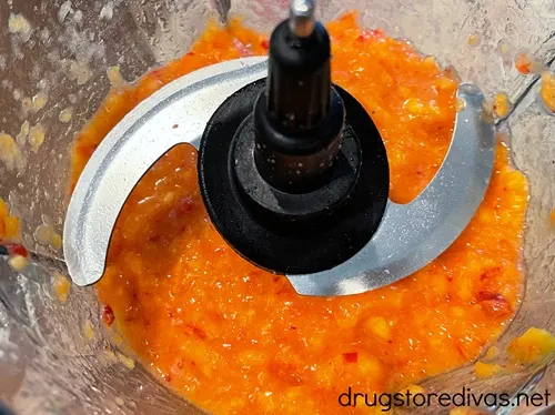 Pulverized peaches in a food processor bowl.