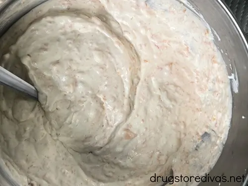 Peach ice cream in a stand mixer bowl.