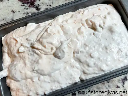 Peach ice cream in a metal bread pan.