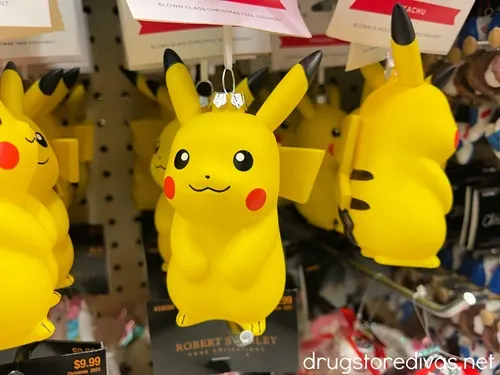 A bunch of Pikachu Christmas ornaments on pegs at a store.