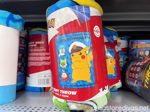A Captain Pikachu blanket on the shelf in a store.