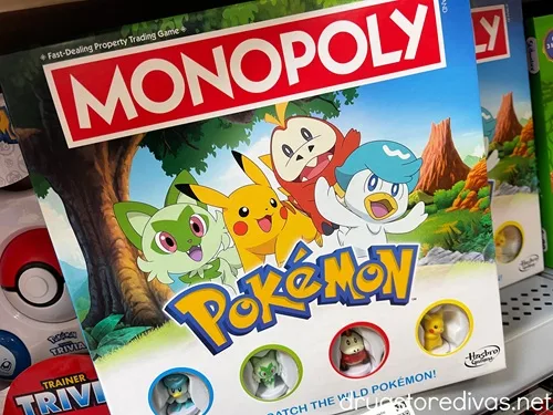 A Pokemon Monopoly game on a shelf in a store.