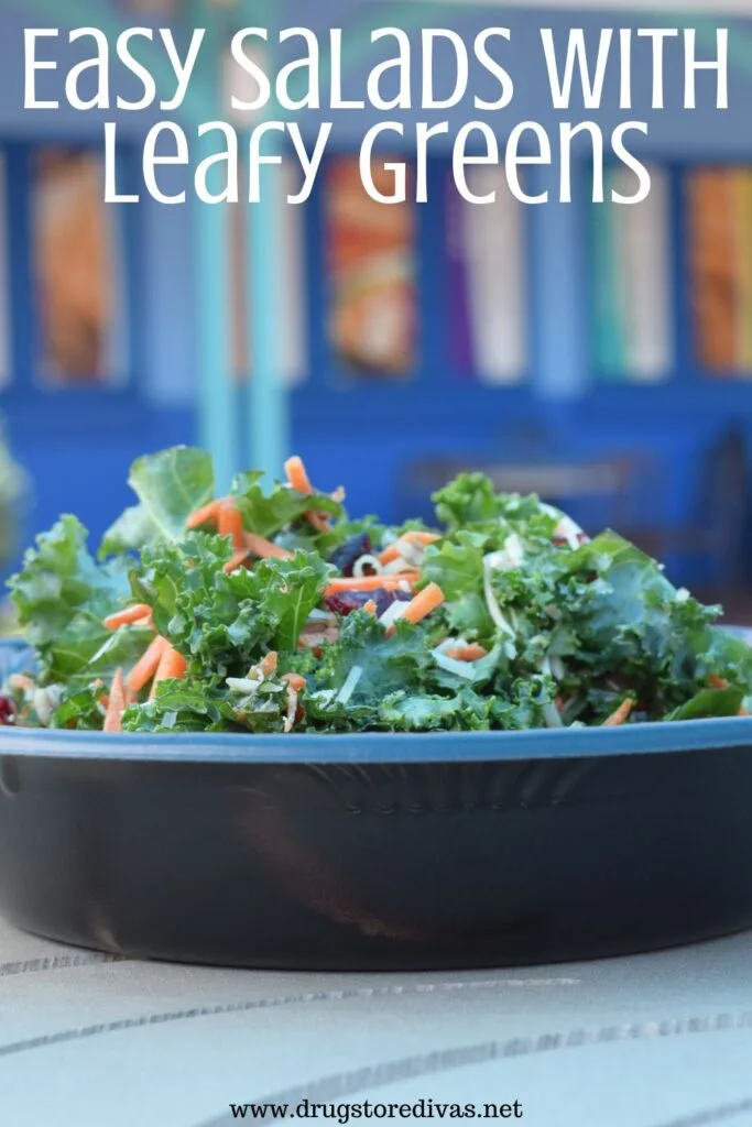 A kale salad in a black bowl with the words "Easy Salads With Leafy Greens" digitally written on top.