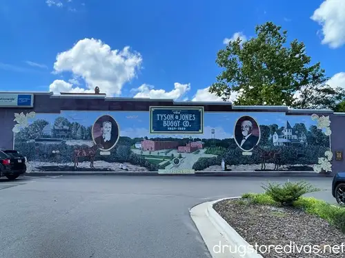 A mural of two men and horse and buggies called Tyson & Jones Buggy Co.