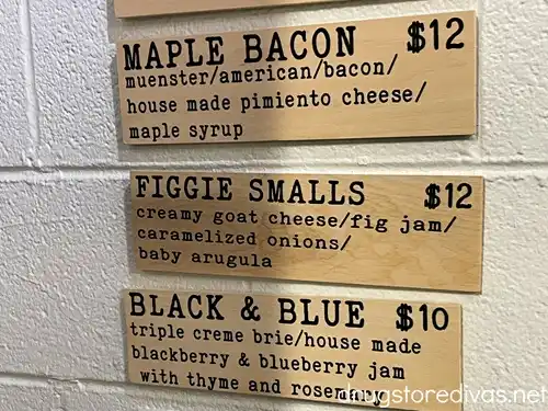 Advertisements for three grilled cheese sandwiches in CheeseSmith in the Cargo District in Wilmington, NC.