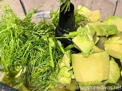 Diced avocado and chopped dill in a blender.