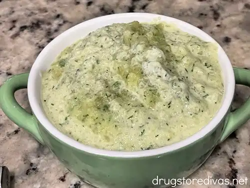Cucumber soup in a green bowl with a white rim.