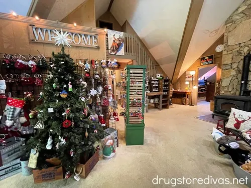 A small living room like area with a fireplace and Christmas tree with items for sale at Fred's General Mercantile in Beech Mountain, NC.