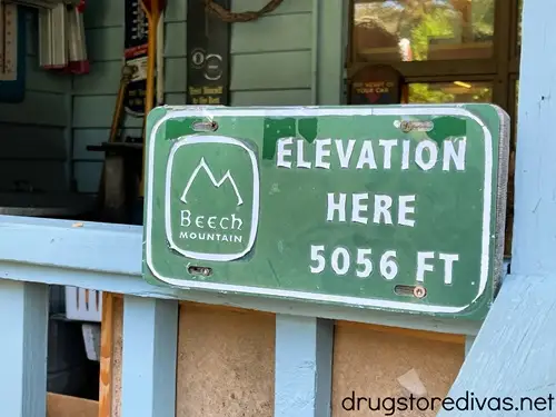 A green sign that says Beech Mountain Elevation here 5056 FT.