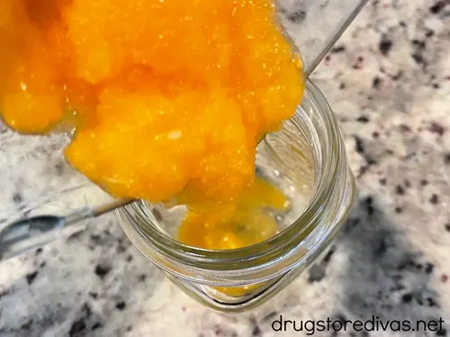 Frozen orange lemonade being poured into a glass.