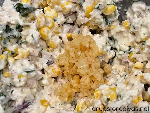 Minced garlic on top of Mexican Street Corn Chicken Salad.