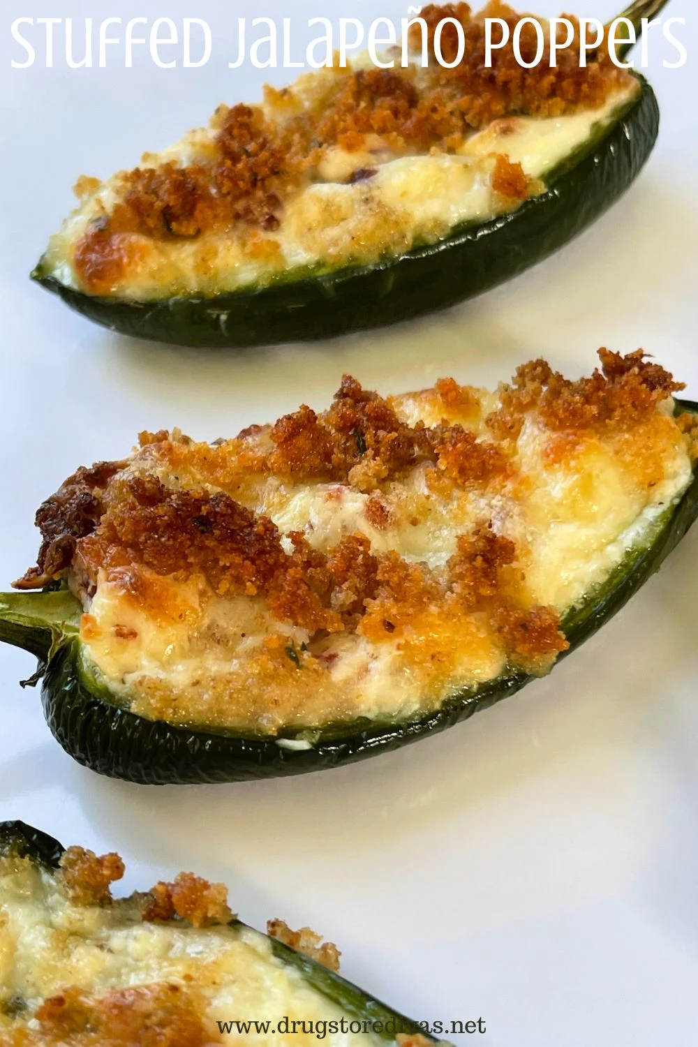 Thee stuffed peppers on a white tray with the words 