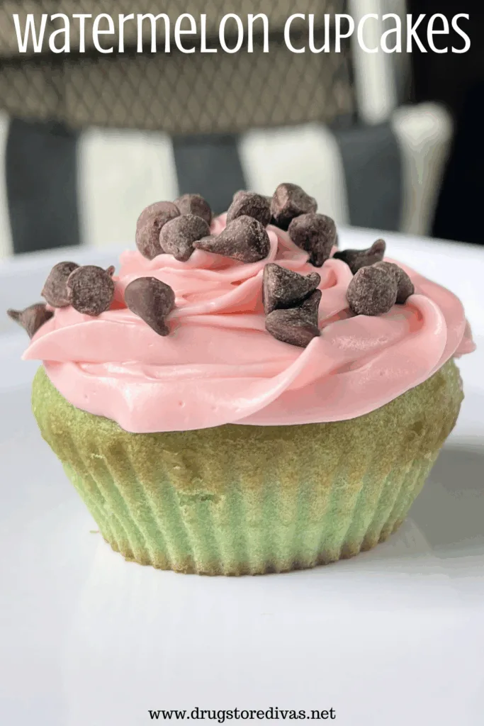 A cupcake with a green bottom and pink icing with mini chocolate chips on top with the words "Watermelon Cupcakes" digitally written on top.