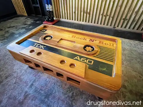 A table shaped like a cassette tape in a room.