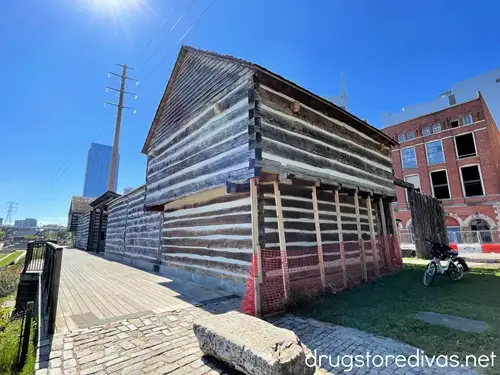 One of the wooden buildings, which is part of Fort Nashborough in Nashville, with a bike off to the side.