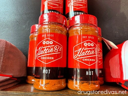 Bottles of Hattie B's hot chicken seasoning on a shelf.