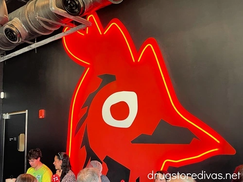 A red chicken painted on a wall inside Hattie B's hot chicken.