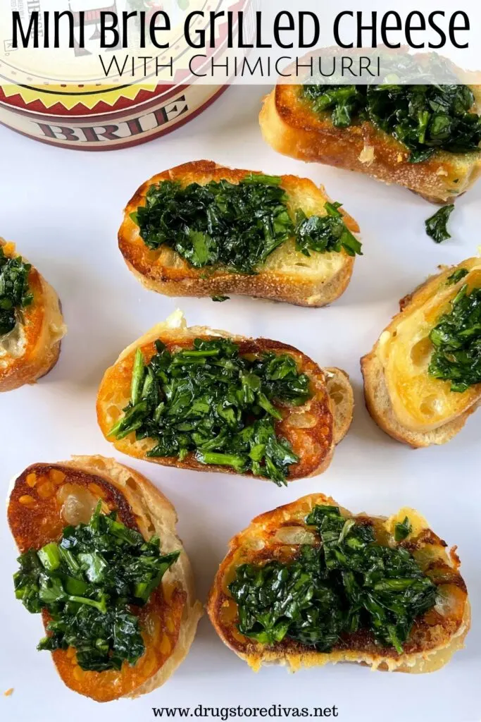 Mini sandwiches with chimichurri on top with a paper container of brie cheese in the back with the words "Mini Brie Grilled Cheese With Chimichurri" digitally written on top.