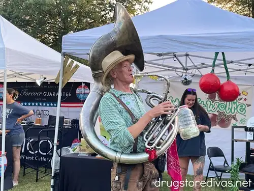 A man playing a French horn at Nashville Oktoberfest.
