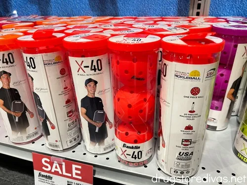 Outdoor Pickleballs on a shelf in a store.