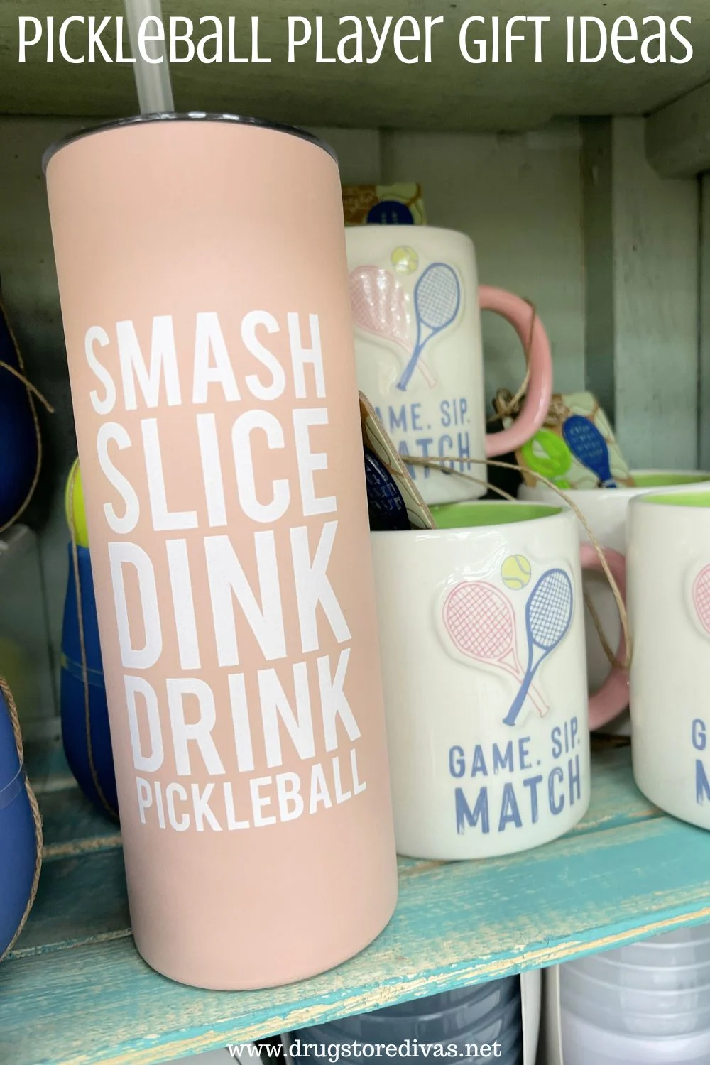 A pink tumbler with a few mugs next to it on a shelf with the words 