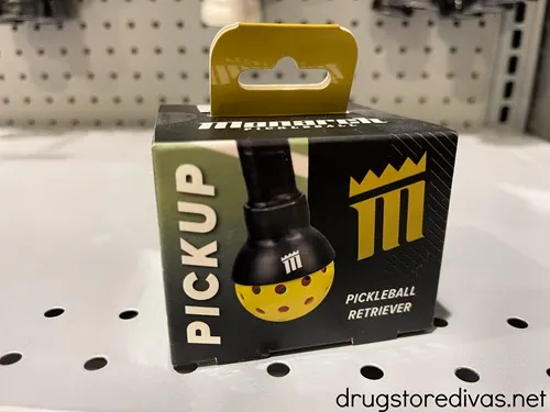 A pickleball retriever in a box on a shelf.