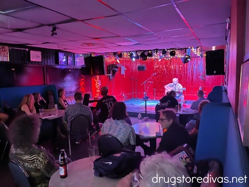 A man on stage, performing to an audience, at Springwater Supper Club & Lounge in Nashville.