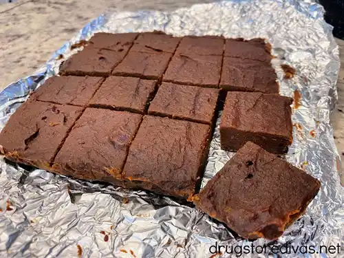 Cut baked brownies on top of a piece of foil.