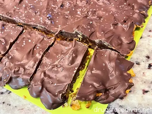 Chocolate Corn Flake Toffee Bark cut into pieces on a cutting board.