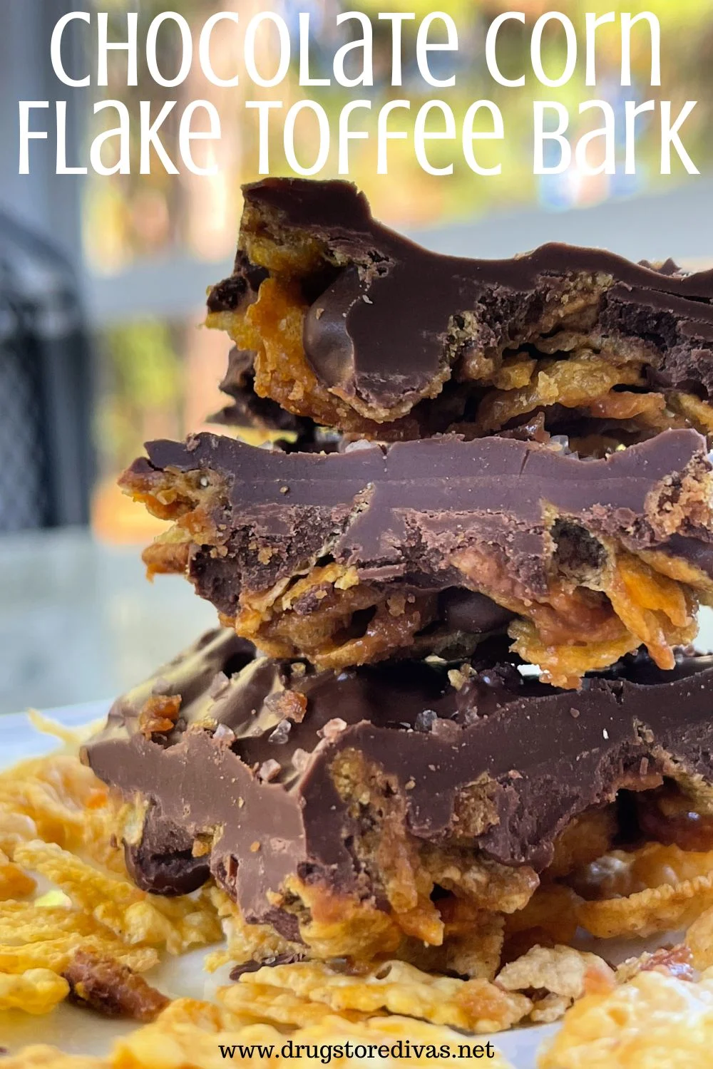 Three pieces of corn flake chocolate bark in a pile of corn flakes with the words 