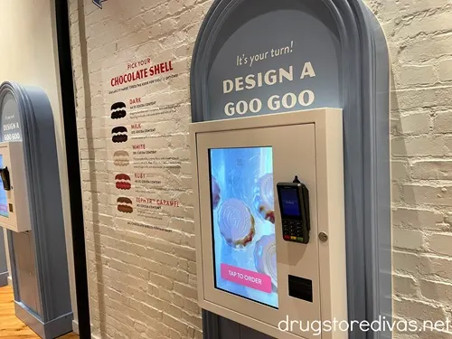 A digital screen on a wall that created a Design A Goo Goo station inside Goo Goo Chocolate in Nashville.