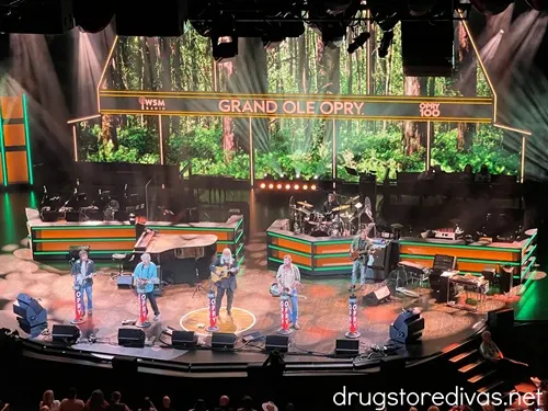 A large band on stage at the Grand Ole Opry.