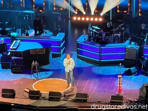 A man on stage performing at the Grand Ole Opry.