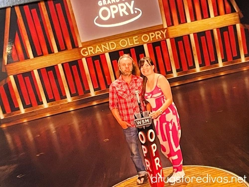 A man and woman standing on the Circle at the Grand Ole Opry stage.