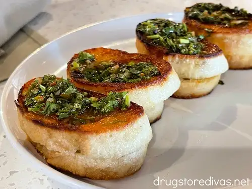 Four mini brie grilled cheese sandwiches on a plate.